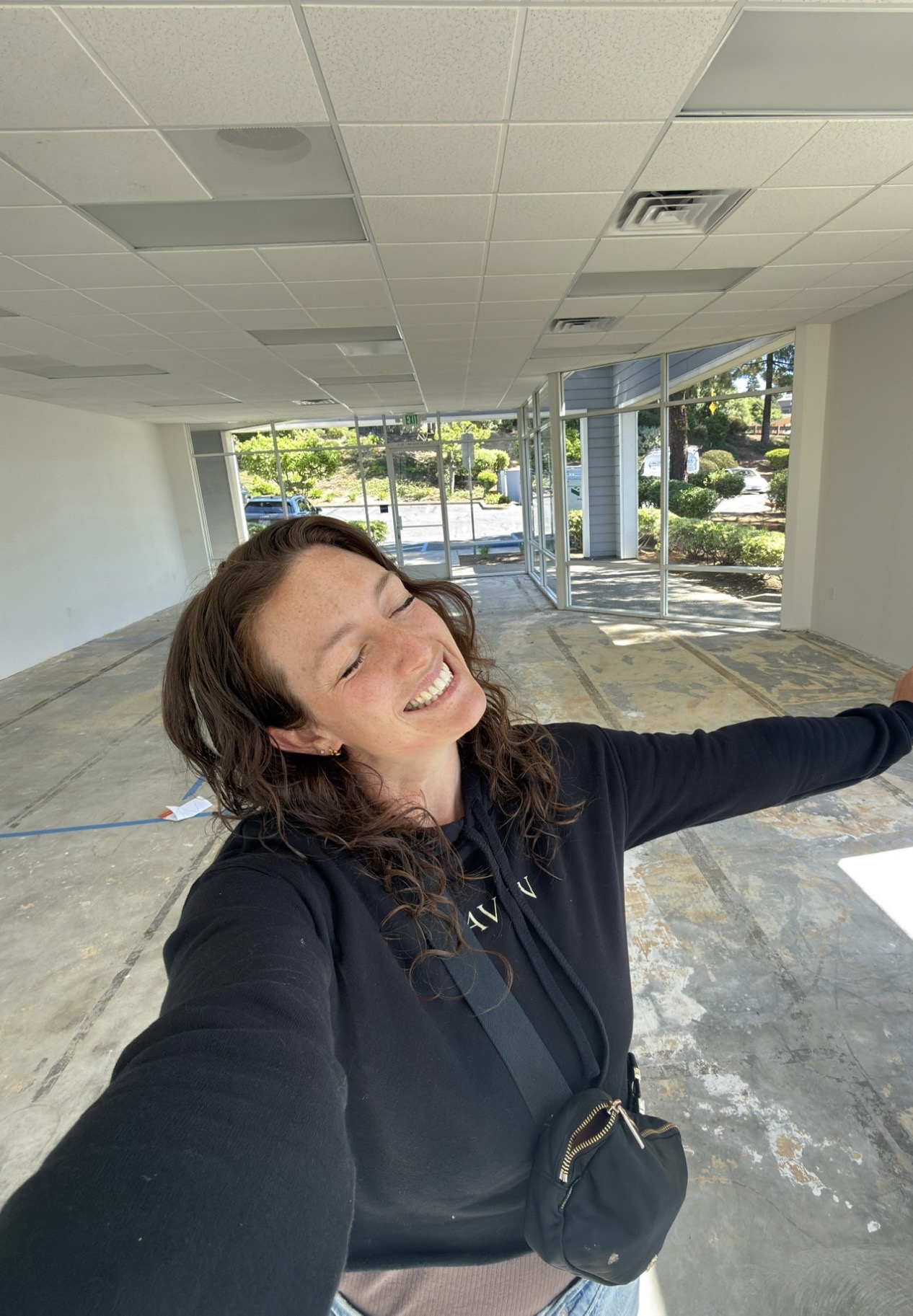 Lyss smiling inside one of her business spaces